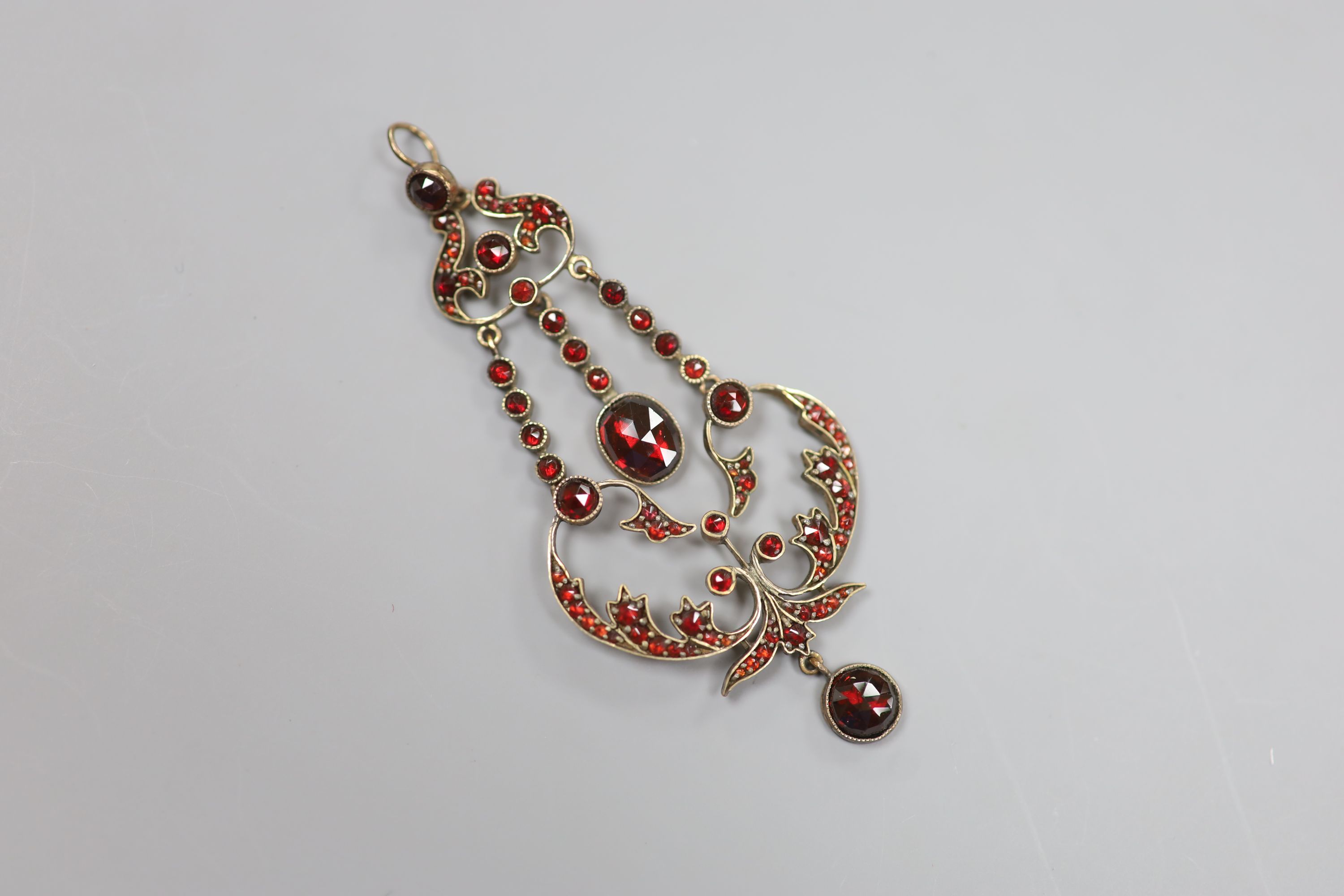 A late Victorian gold plated and facet garnet garnet cluster set drop pendant, overall 75cm, 6.9 grams.